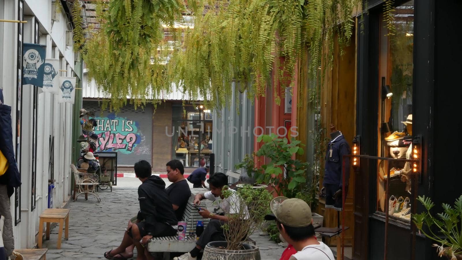 BANGKOK, THAILAND - 10 JULY, 2019: People walking at the Camp vintage flea market near Chatuchak. Design of retro style boutique art shops of antiques. Decoration of popular fashion city landmark