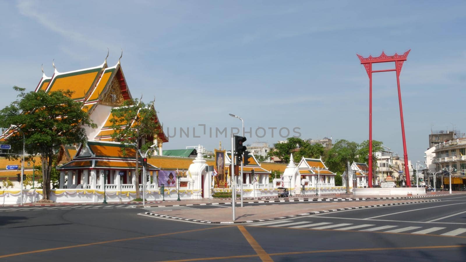 BANGKOK, THAILAND - 11 JULY, 2019: Giant Swing religios historic monument near traditional wat Suthat buddist temple. Iconic city view, cultural symbol. Famous landmark and classic tourist attraction. by DogoraSun