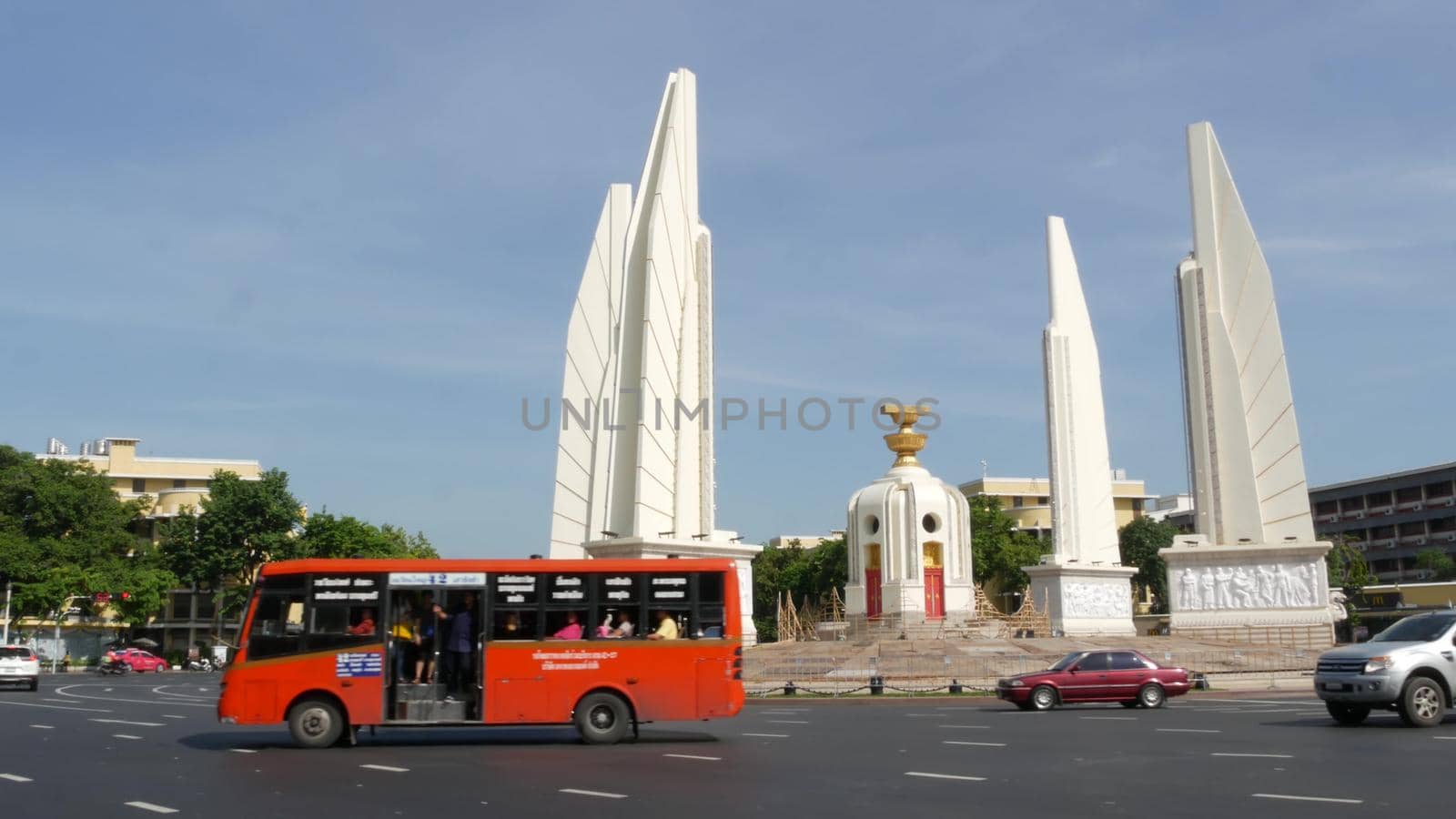 BANGKOK, THAILAND - 11 JULY, 2019: Rush hour traffic near Democracy Monument in capital. Famous asian landmark and travel destination. Democratic and patriotic symbol and public transport in downtown.