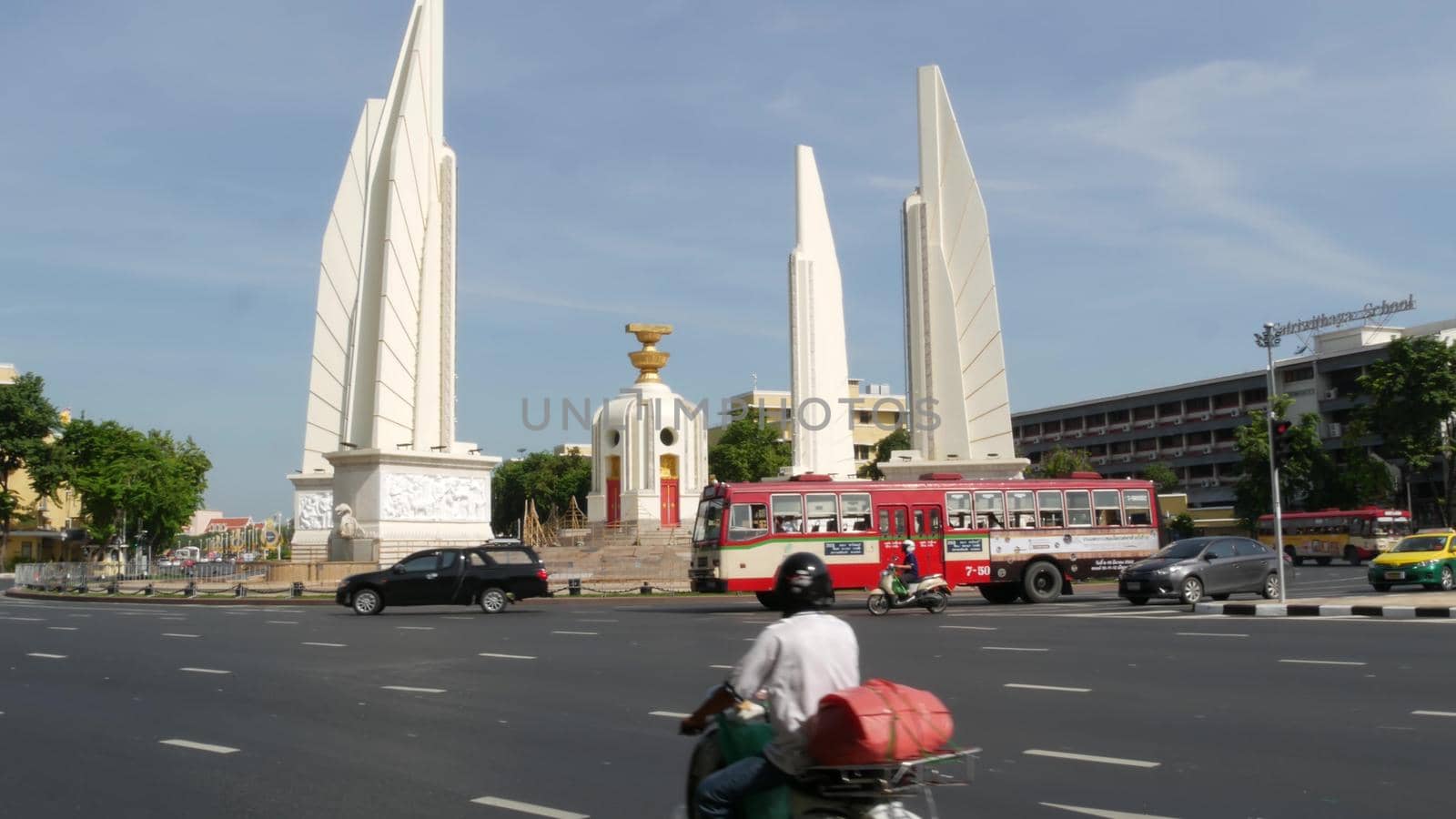 BANGKOK, THAILAND - 11 JULY, 2019: Rush hour traffic near Democracy Monument in capital. Famous asian landmark and travel destination. Democratic and patriotic symbol and public transport in downtown by DogoraSun