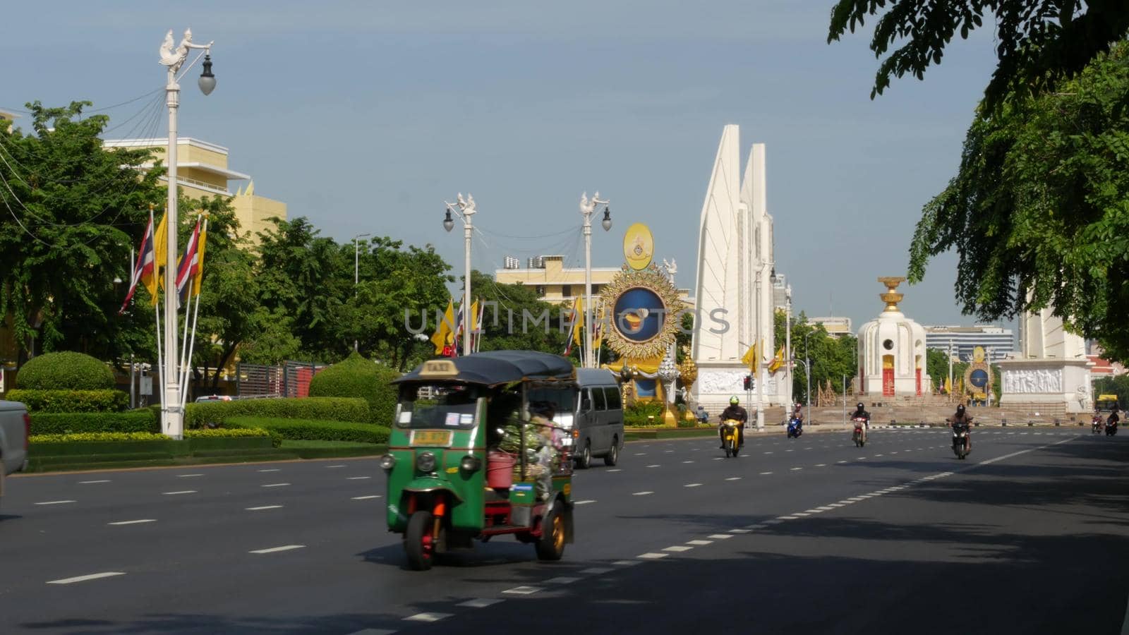 BANGKOK, THAILAND - 11 JULY, 2019: Rush hour traffic near Democracy Monument in capital. Famous asian landmark and travel destination. Democratic and patriotic symbol and public transport in downtown by DogoraSun