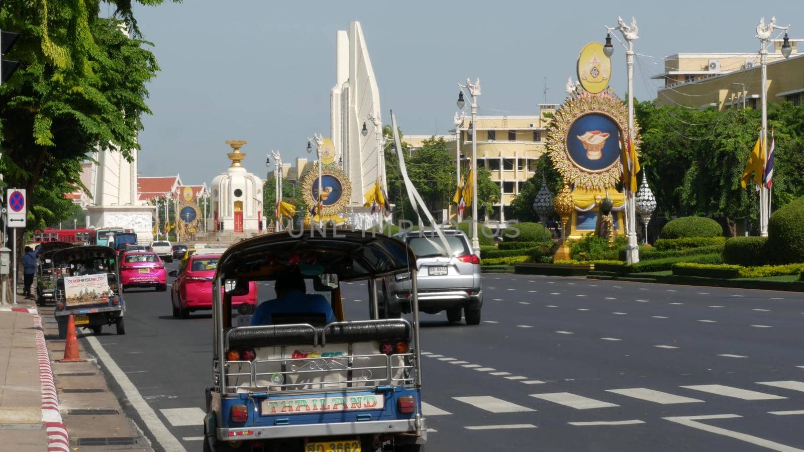 BANGKOK, THAILAND - 11 JULY, 2019: Rush hour traffic near Democracy Monument in capital. Famous asian landmark and travel destination. Democratic and patriotic symbol and public transport in downtown by DogoraSun