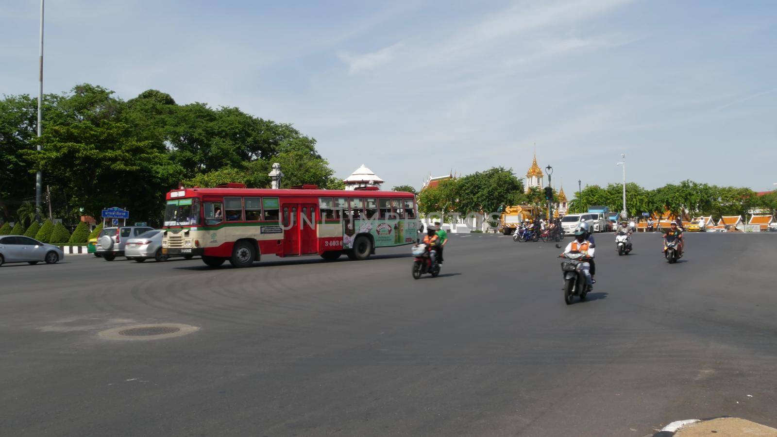 BANGKOK, THAILAND - 11 JULY, 2019: Rush hour traffic near Wat Saket in capital. Famous asian landmark and travel destination. Ancient religious monastery and public transport on the road in downtown