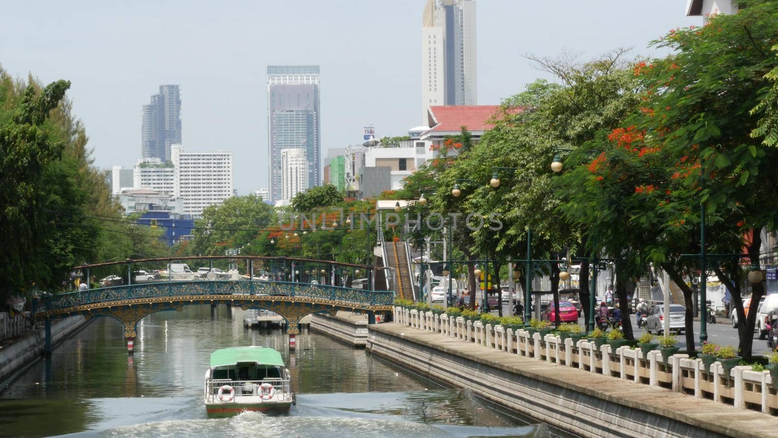 BANGKOK, THAILAND, 11 JULY 2019: Canal as classic typical water way for public passengers transportation. Street city life on khlong. Local people use boat as traditional transport during traffic jam by DogoraSun