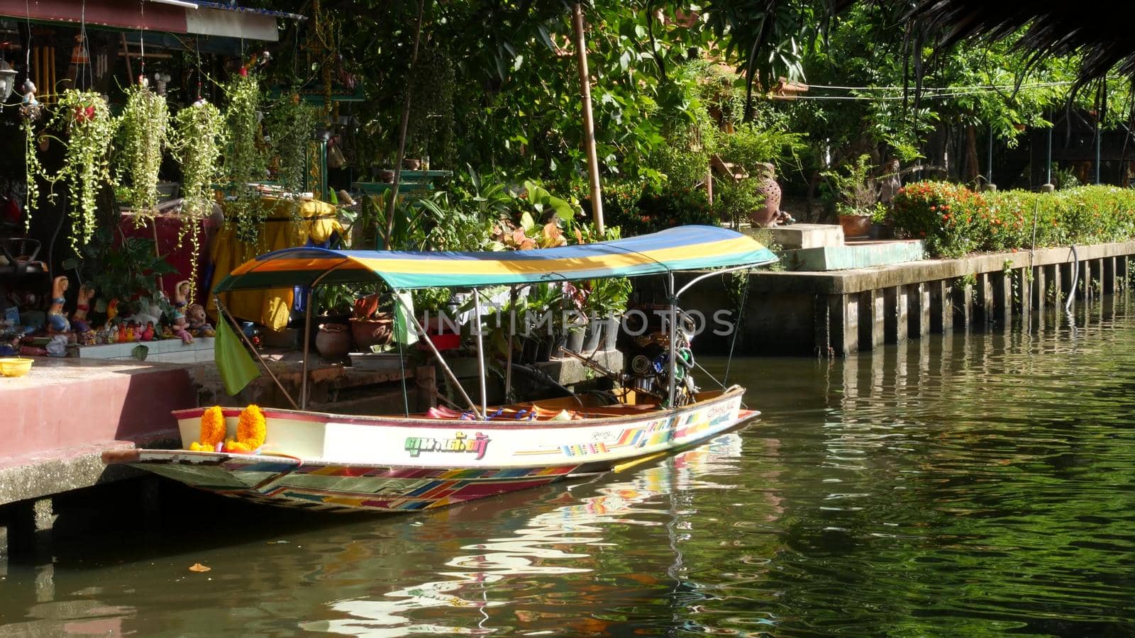 BANGKOK, THAILAND - 13 JULY 2019: Traditional asian river canal. View of calm khlong channel and residential houses in Siam. Classic iconic water way in Krungtep.