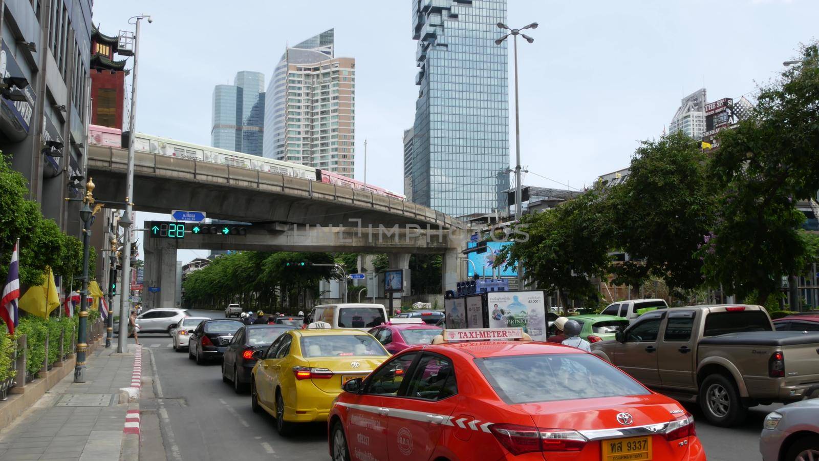 BANGKOK, THAILAND - 13 JULY, 2019: Mahanakhon King Power skyscraper in modern Sathorn financial business district. Maha Nakhon - tallest futuristic building. Rush hour traffic, cars and bts skytrain.