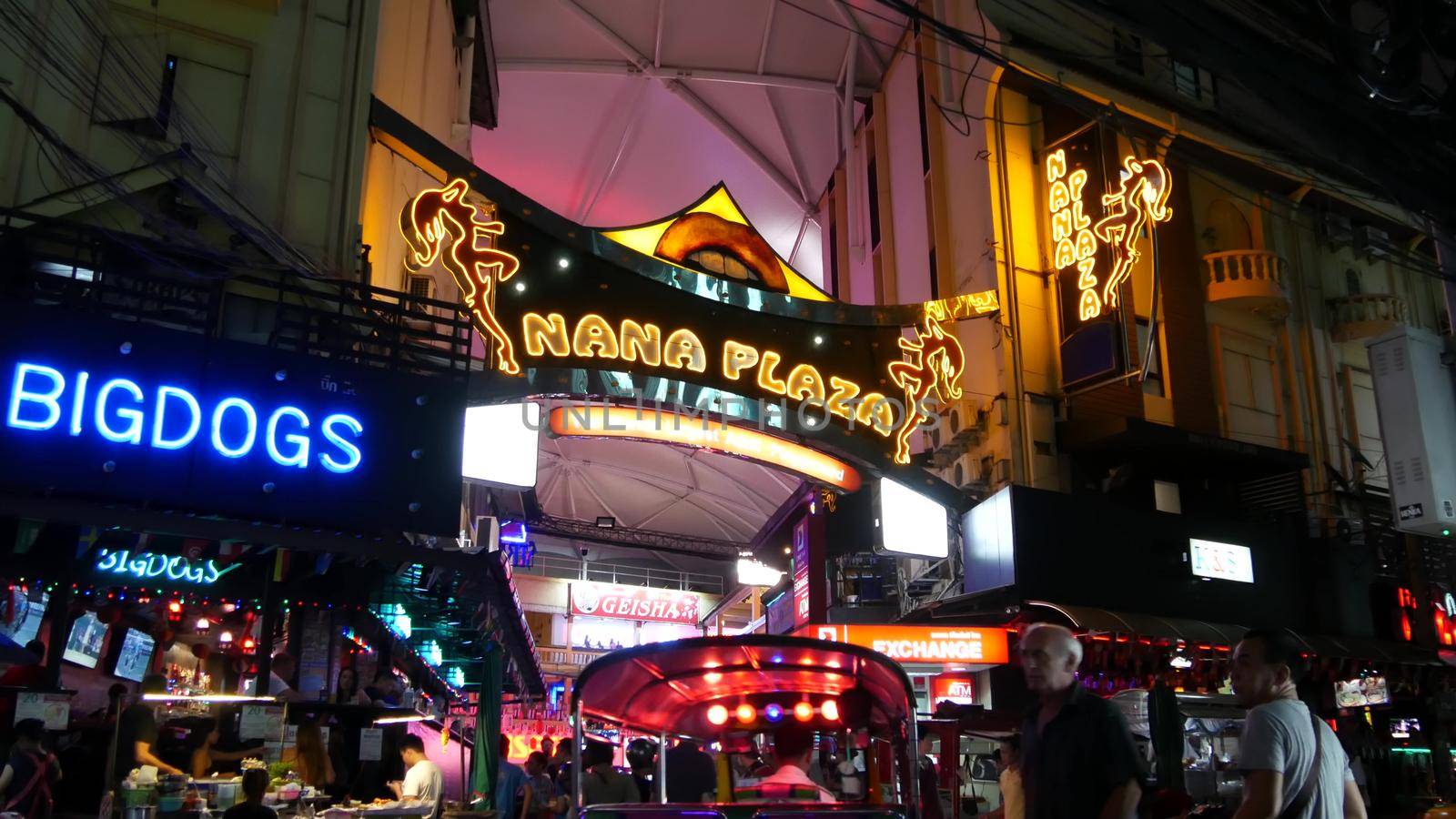 BANGKOK, THAILAND,13 JULY 2019 Vivid neon sign glowing, Nana Plaza street. Nightlife in erotic Red light district soi. Illuminated bar and adult go-go show club. Night life tourist entertainment by DogoraSun