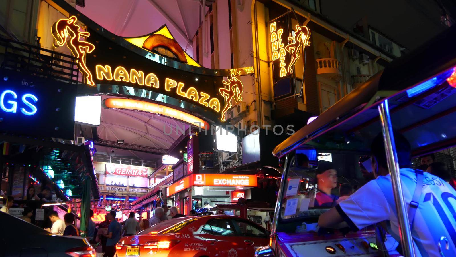 BANGKOK, THAILAND,13 JULY 2019 Vivid neon sign glowing, Nana Plaza street. Nightlife in erotic Red light district soi. Illuminated bar and adult go-go show club. Night life tourist entertainment by DogoraSun