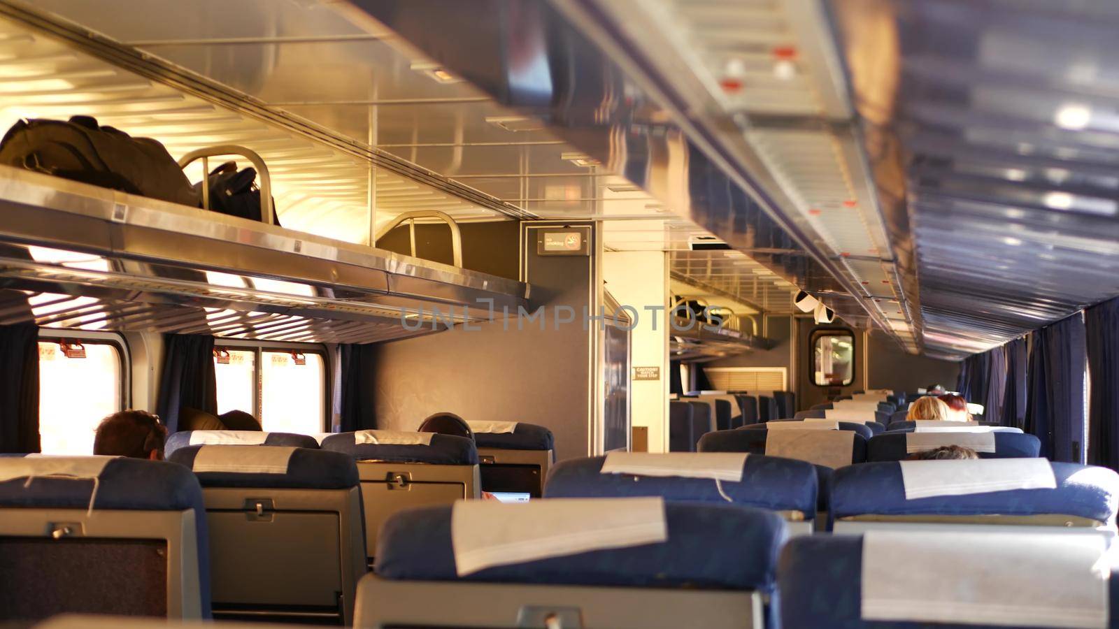 LOS ANGELES, CALIFORNIA, USA - 24 OCT 2019: Amtrak Pacific Surfliner commuter, express train car inside. Passenger rapid rail transportation along the ocean. Railway on west coast. Railroad in suburb by DogoraSun