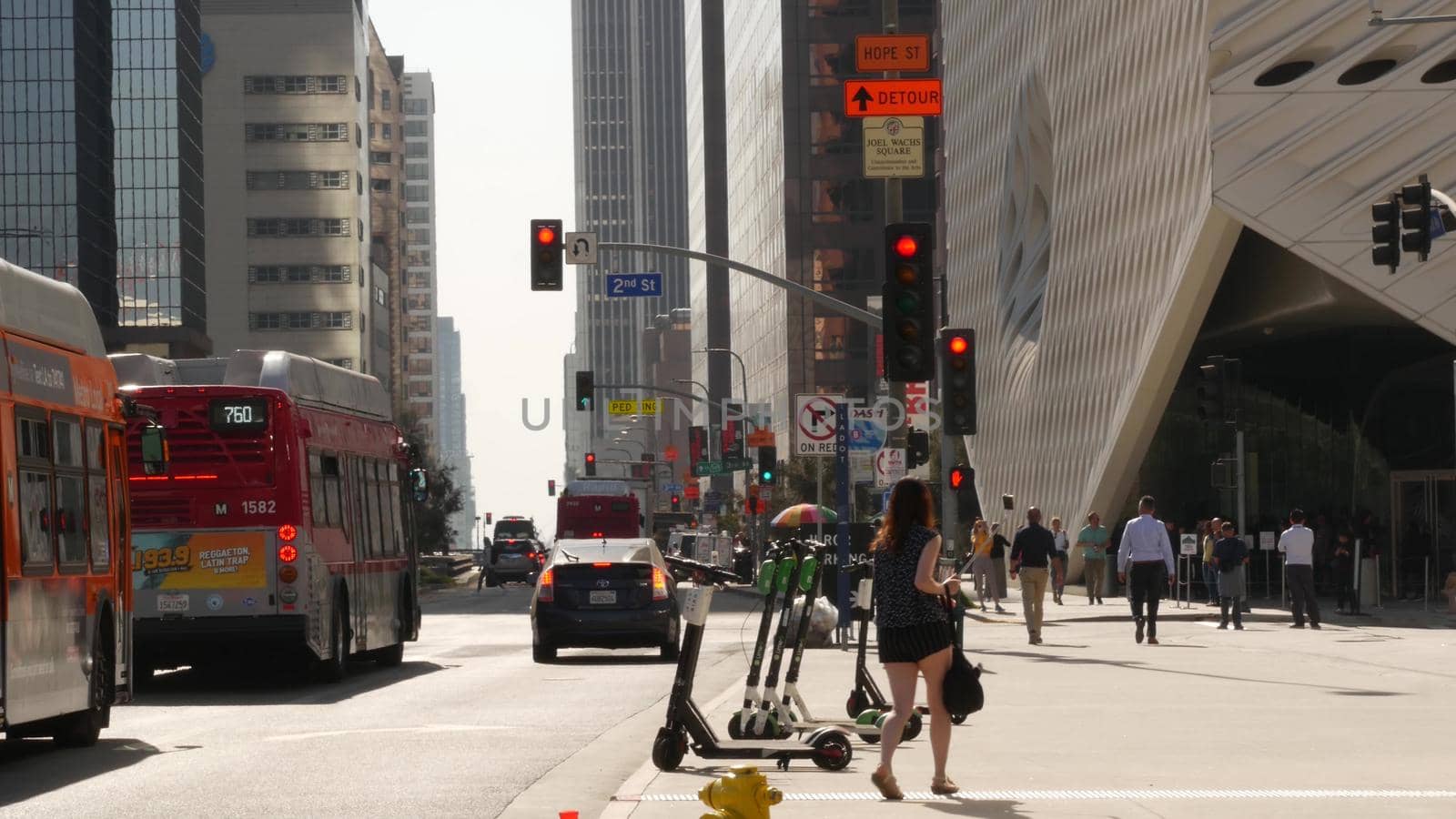 LOS ANGELES, CALIFORNIA, USA - 30 OCT 2019: People walking in metropolis, pedestrians on walkway in urban downtown. Citizens on street in financial district. City dwellers in LA among skyscrapers.