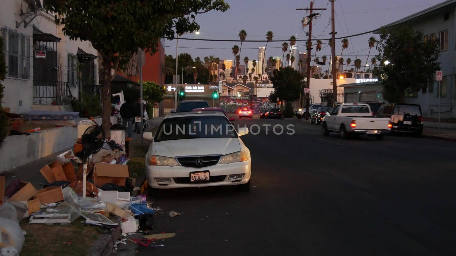 LOS ANGELES, CALIFORNIA, USA - 30 OCT 2019: Stack of waste on street roadside. Junk problem and recycling issues, pile of trash and garbage on sidewalk. Heap of mess, rubbish in metropolis downtown.