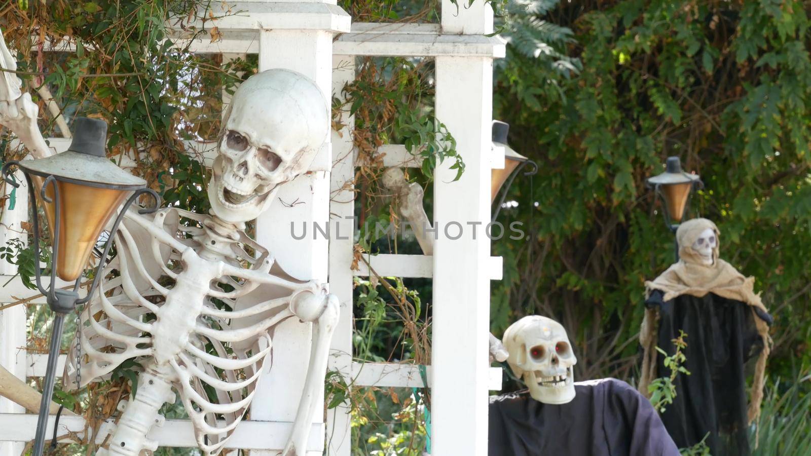 LOS ANGELES, CALIFORNIA, USA - 29 OCT 2019: Scary festival decorations of a house, Happy Halloween holiday. Classic garden with Pumpkin, Bones and Skeleton. Traditional party decor. American culture.