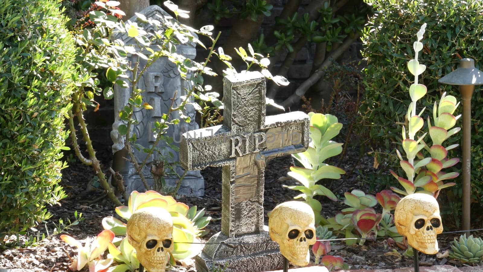 LOS ANGELES, CALIFORNIA, USA - 29 OCT 2019: Scary festival decorations of a house, Happy Halloween holiday. Classic garden with Pumpkin, Bones and Skeleton. Traditional party decor. American culture.