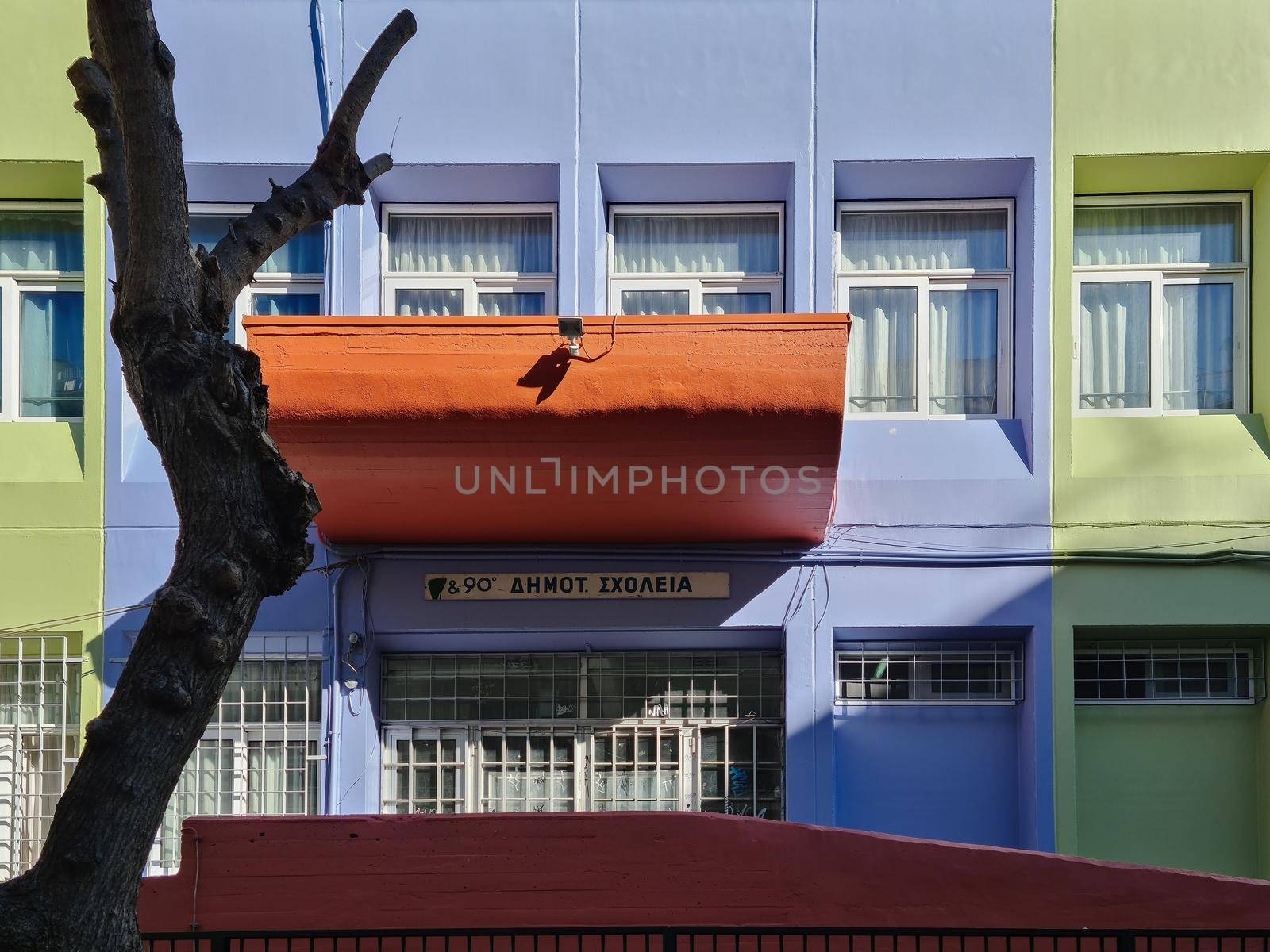 Day view of colorful building for first stage children basic tuition-free education called dimotiko, without students
