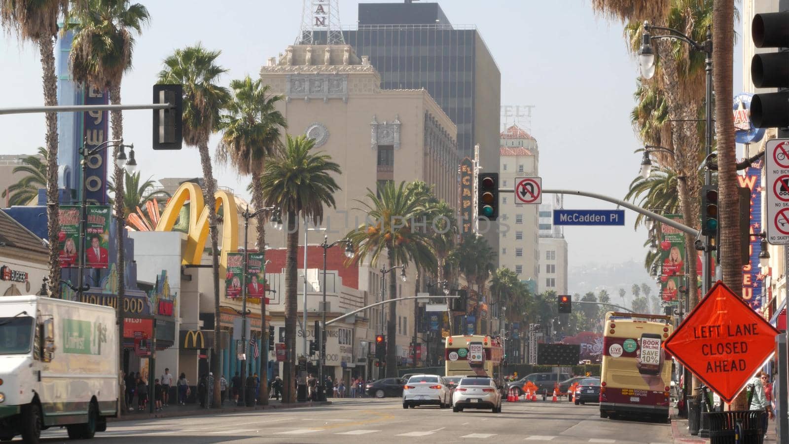 LOS ANGELES, CALIFORNIA, USA - 7 NOV 2019: Walk of fame promenade, Hollywood boulevard in LA city. Pedastrians walking on sidewalk of street. Entertainment and cinema industry iconic tourist landmark.