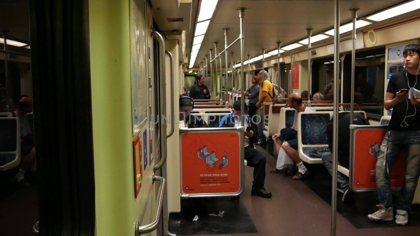 LOS ANGELES, CALIFORNIA, USA - 7 NOV 2019: Metro Rail transportation system. Metropolitan public passenger railway transport infrastructure. Citizens inside underground subway. People in LA City by DogoraSun