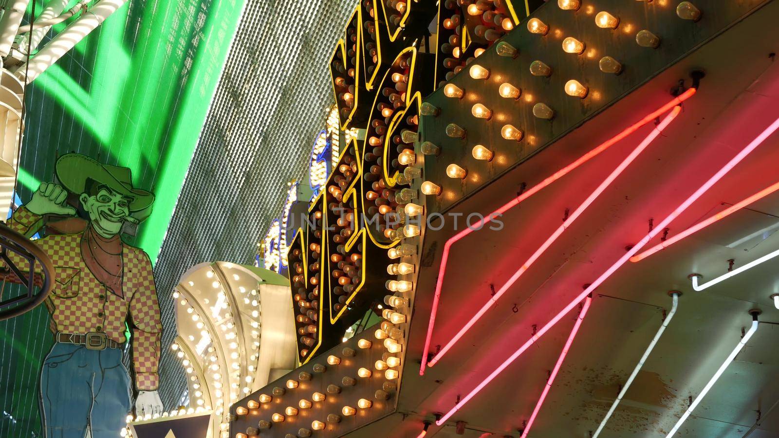 LAS VEGAS, NEVADA USA - 12 DEC 2019: Cowboy Vegas Vic, old neon sign glowing, Freemont street in sin city. Illuminated retro welcoming signboard to Pioneer Club casino. Vintage greeting man at night.