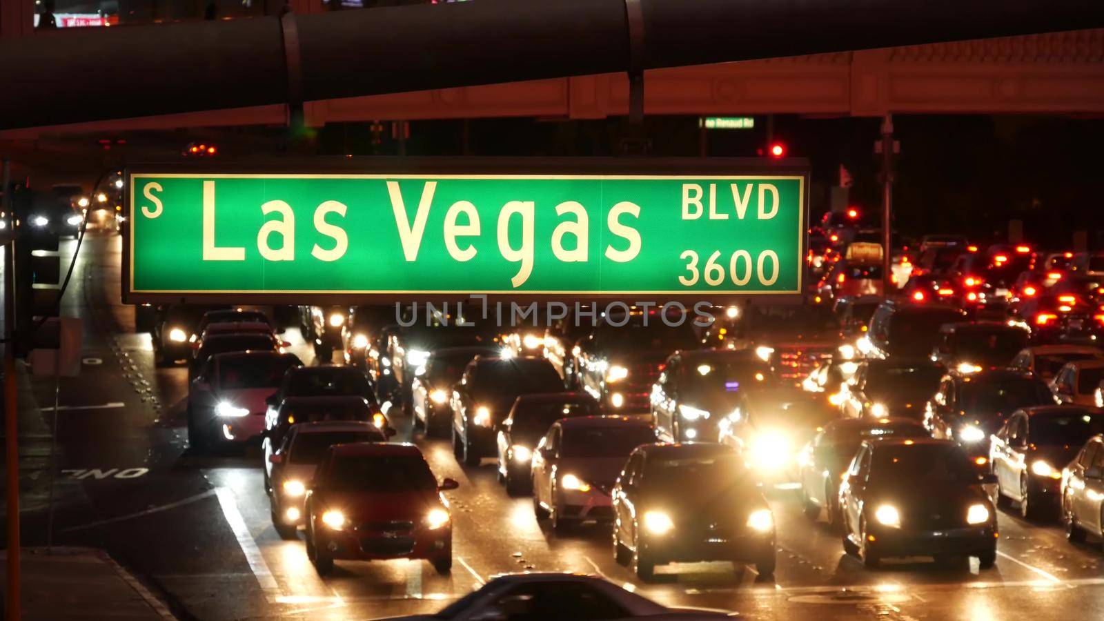 LAS VEGAS, NEVADA USA - 13 DEC 2019: Traffic sign glowing on The Strip in fabulous sin city. Iconic signboard on the road to Fremont street. Illuminated symbol of casino, money playing and betting by DogoraSun