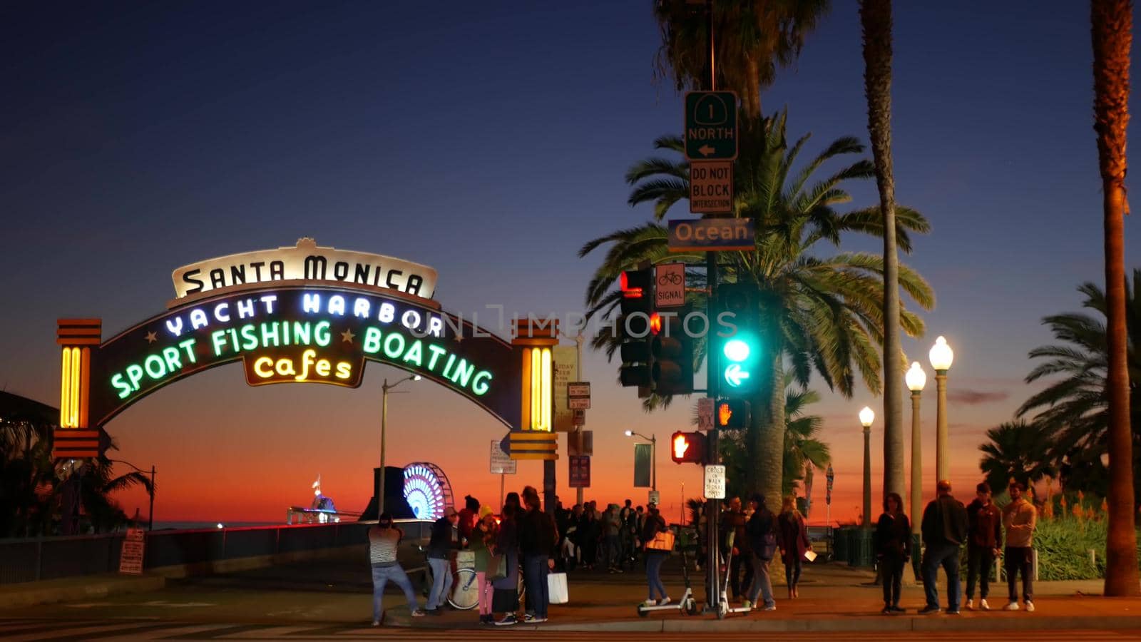 SANTA MONICA, LOS ANGELES CA USA - 19 DEC 2019: Summertime iconic vintage symbol. Classic illuminated retro sign on pier. California summertime aesthetic. Glowing lettering on old-fashioned signboard.
