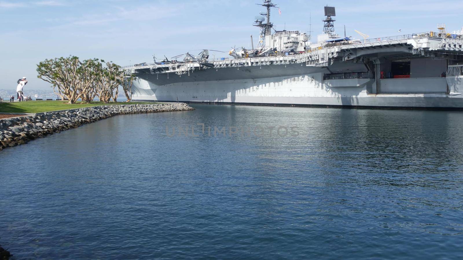 SAN DIEGO, CALIFORNIA USA - 15 JAN 2020: USS Midway military aircraft carrier, historic war ship. Naval army battleship. Maritime warship, legend of navy fleet near Unconditional Surrender Statue by DogoraSun