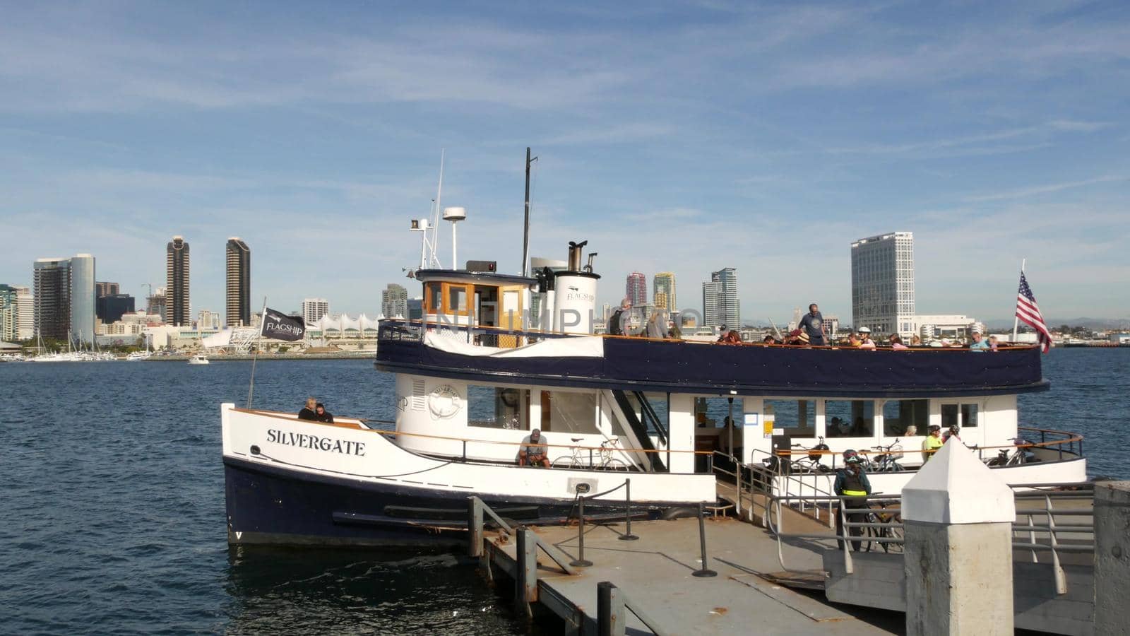 SAN DIEGO, CALIFORNIA USA - 30 JAN 2020: Silvergate passenger ferry boat near pier, Coronado island landing, Flagship public transportation. Metropolis urban skyline, highrise skyscrapers near harbor.