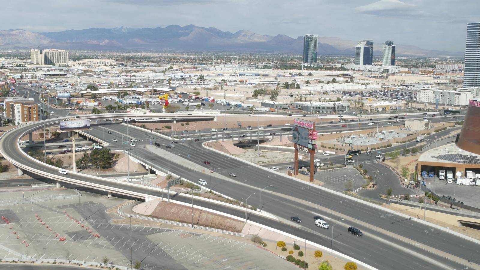 LAS VEGAS, NEVADA USA - 7 MAR 2020: Sin city in Mojave desert from above. Traffic highway in valley with arid climate. Aerial view of road in tourist metropolis. Gambling and betting area with casino.