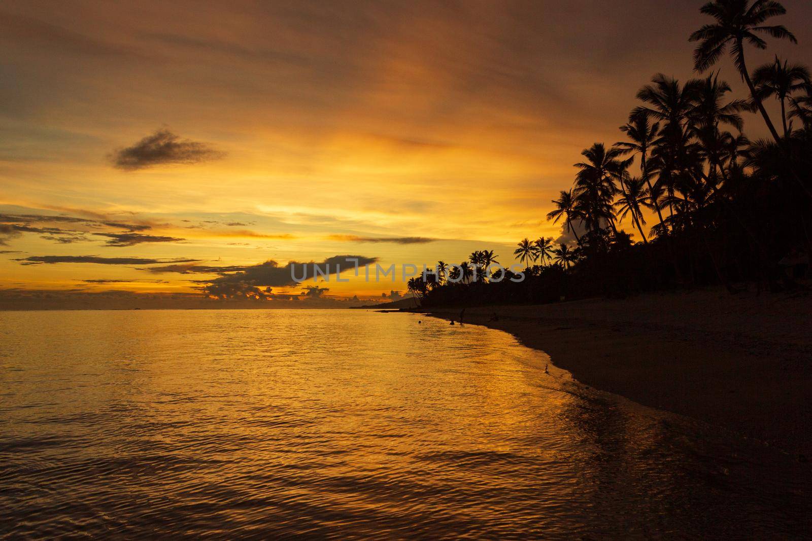 Colorful sunrise on Tambua Sands Beach on Fiji Island, Fiji.