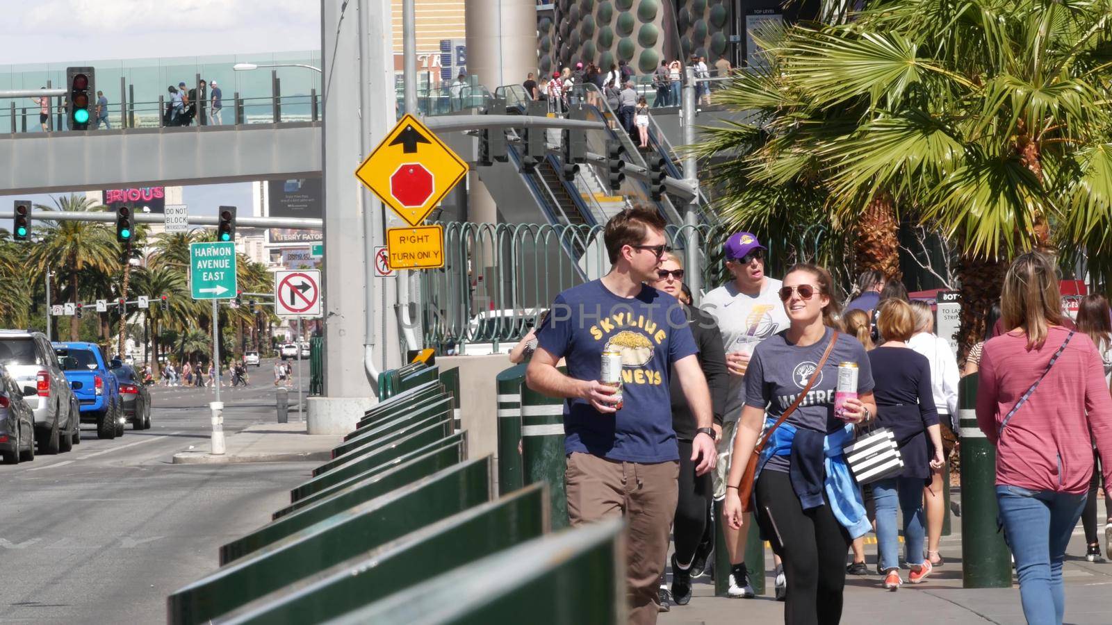 LAS VEGAS, NEVADA USA - 7 MAR 2020: People on pedestrian walkway. Multicultural men and women walking on city promenade. Crowd of citizens on sidewalk. Diversity of multiracial faces in metropolis by DogoraSun