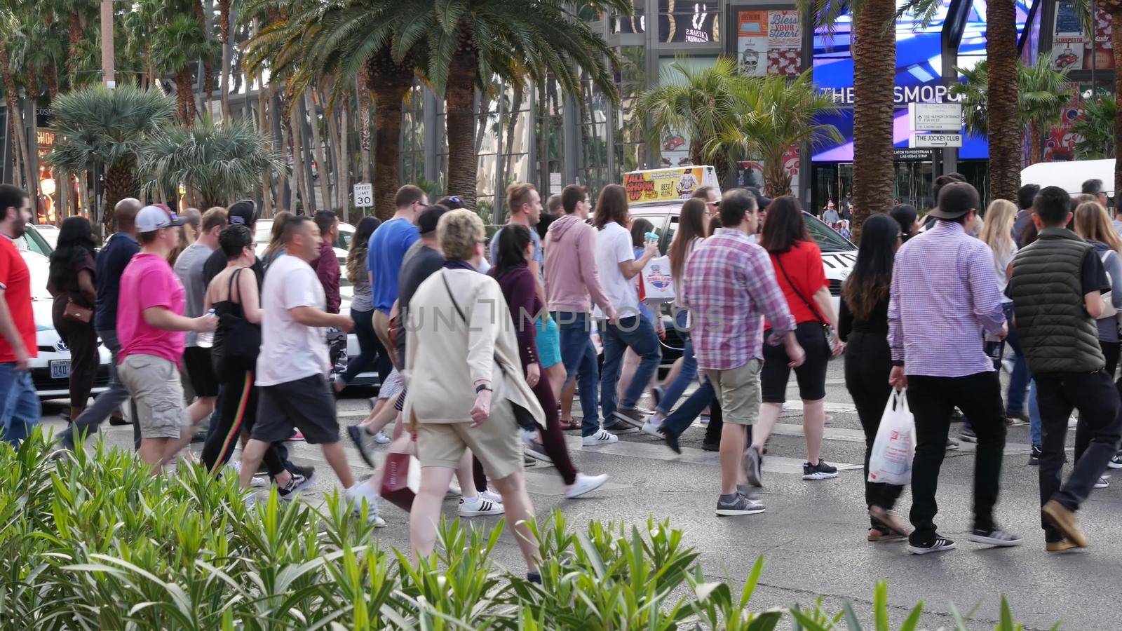 LAS VEGAS, NEVADA USA - 7 MAR 2020: People on pedestrian walkway. Multicultural men and women walking on city promenade. Crowd of citizens on sidewalk. Diversity of multiracial faces in metropolis.