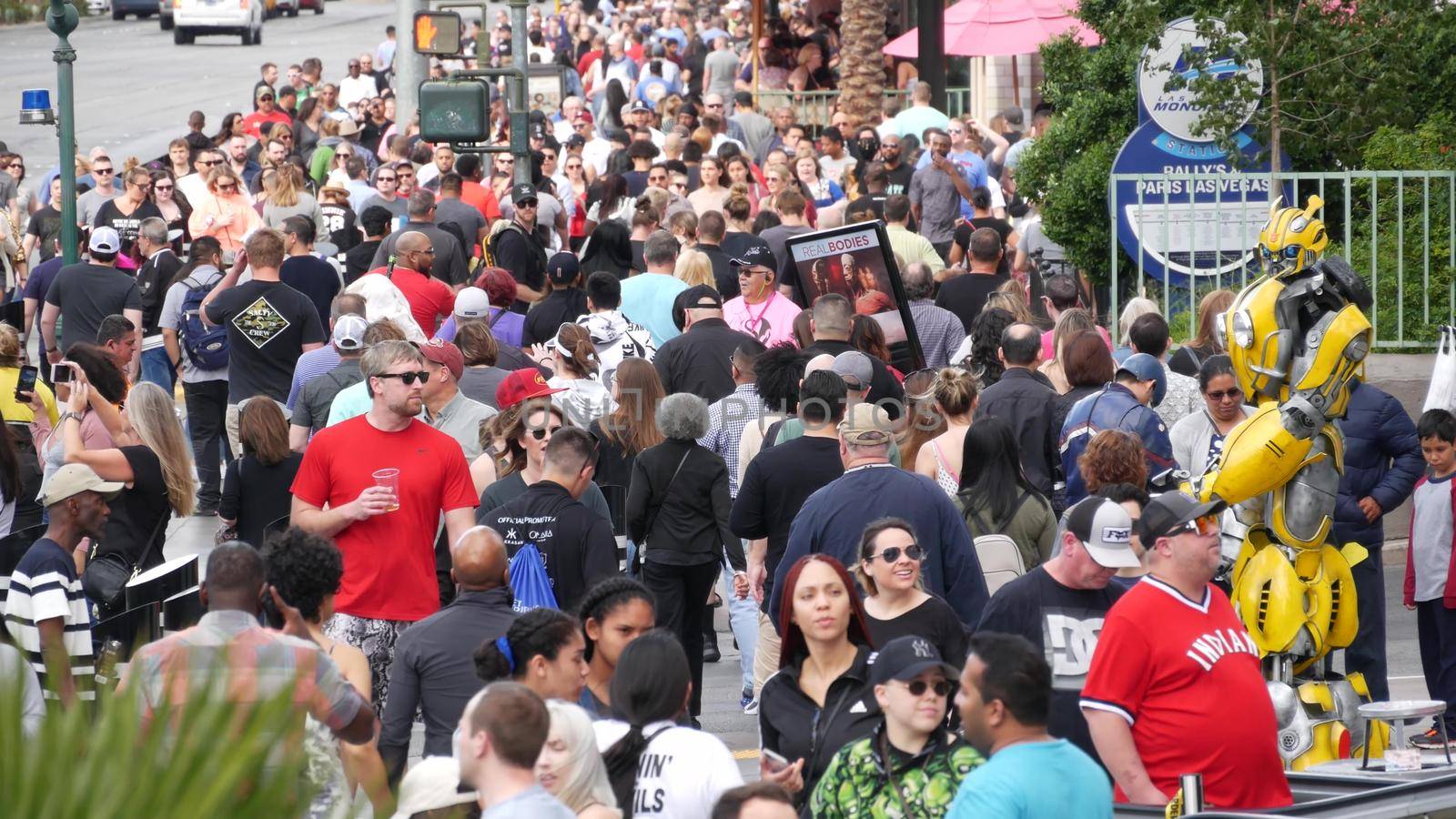 LAS VEGAS, NEVADA USA - 7 MAR 2020: People on pedestrian walkway. Multicultural men and women walking on city promenade. Crowd of citizens on sidewalk. Diversity of multiracial faces in metropolis.