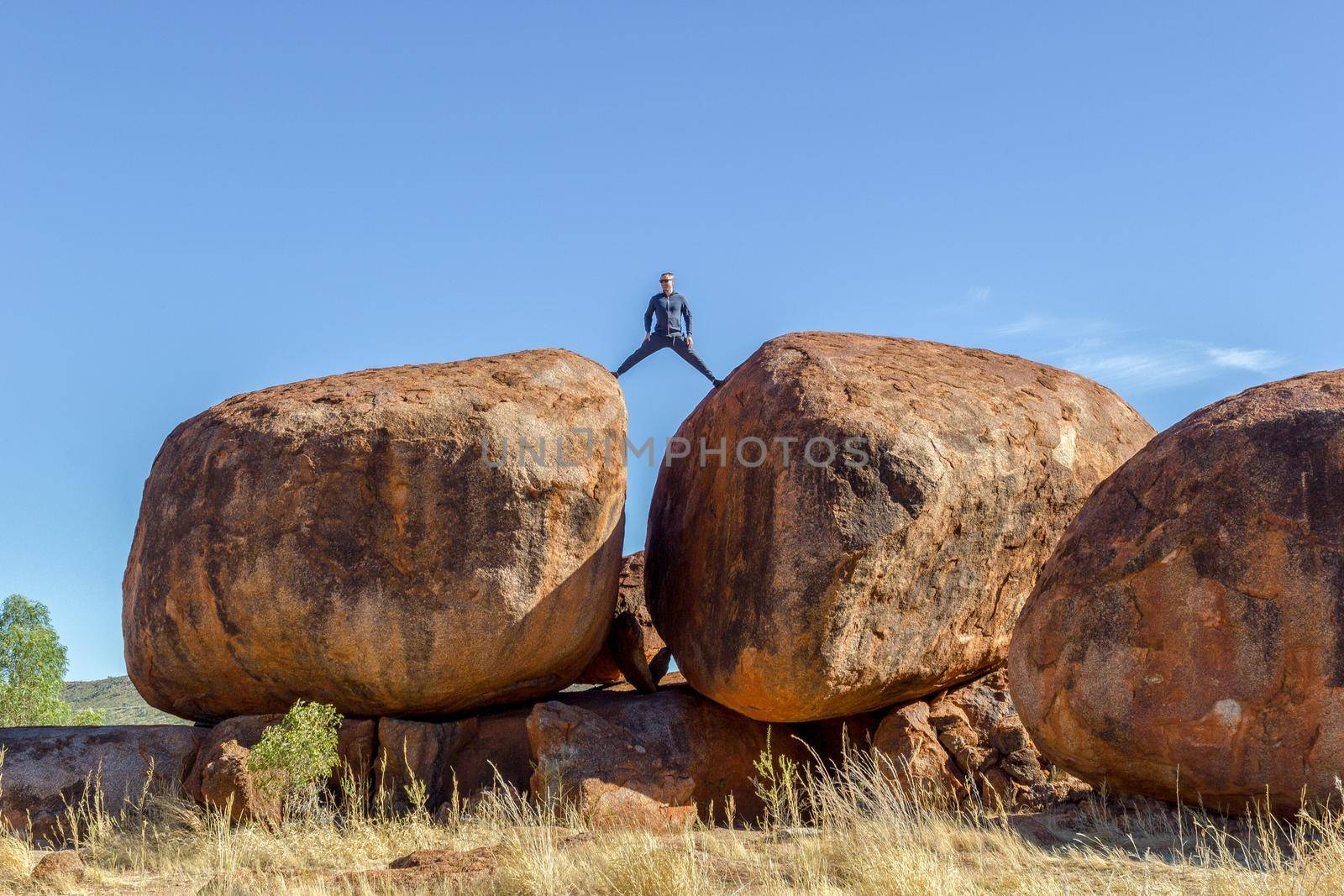 Man standing on Devils Marbels national park, outback, northern territory