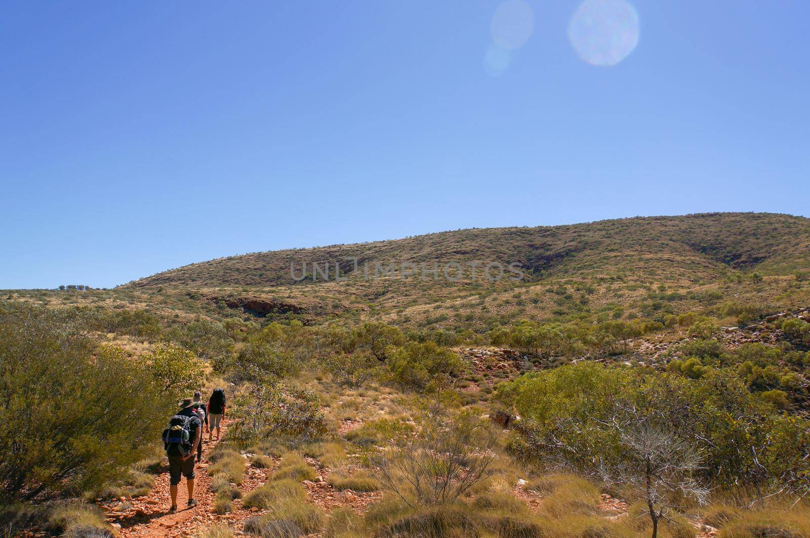 a group of Hikers on the way to the top of Mount Sonder just outside Alice Springs, West MacDonnel National Park, Australia by bettercallcurry