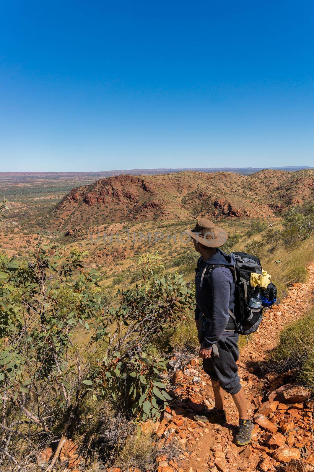 man enjoying view after a hike to the top of Mount Sonder just outside Alice Springs, West MacDonnel National Park, Australia by bettercallcurry