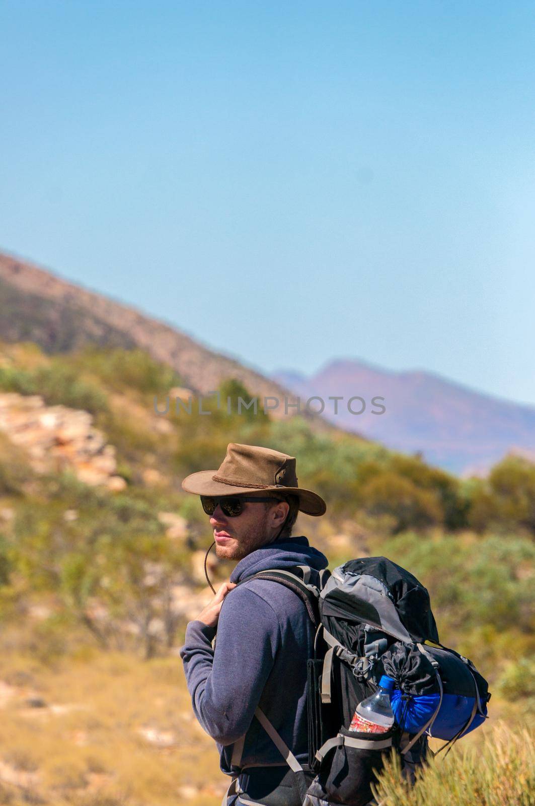 man enjoying view after a hike to the top of Mount Sonder just outside Alice Springs, West MacDonnel National Park, Australia by bettercallcurry