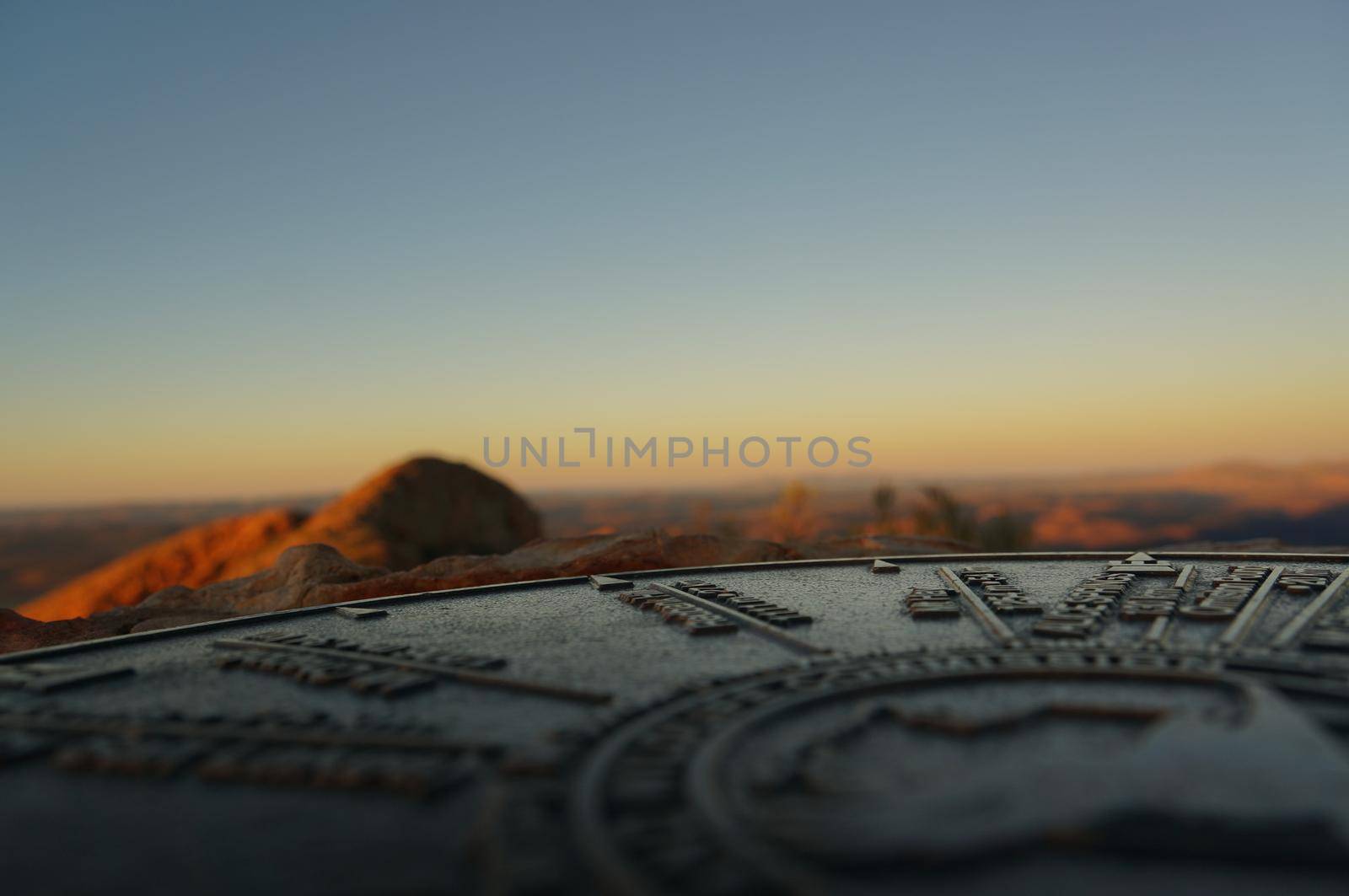 close up of a compass from the the top of Mount Sonder just outside of Alice Springs, West MacDonnel National Park, Australia by bettercallcurry
