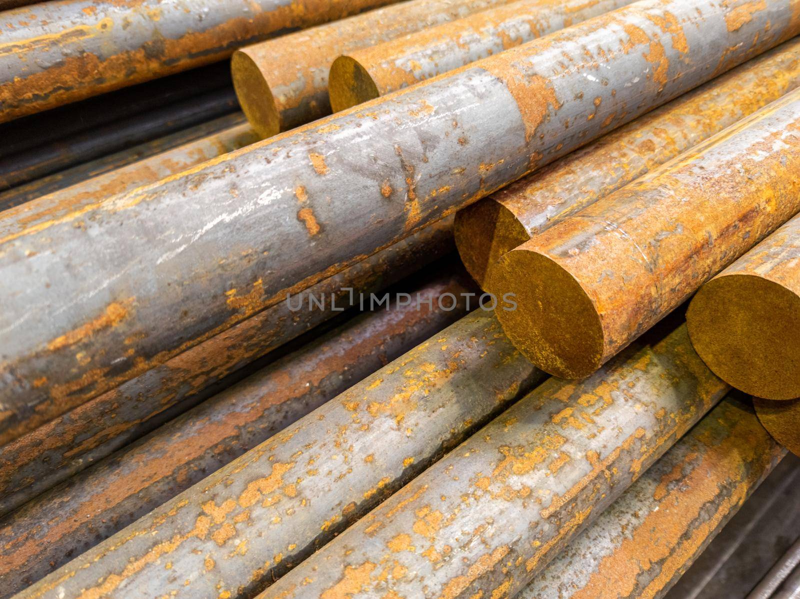 rusted long round steel bars pack - close-up with selective focus and background blur