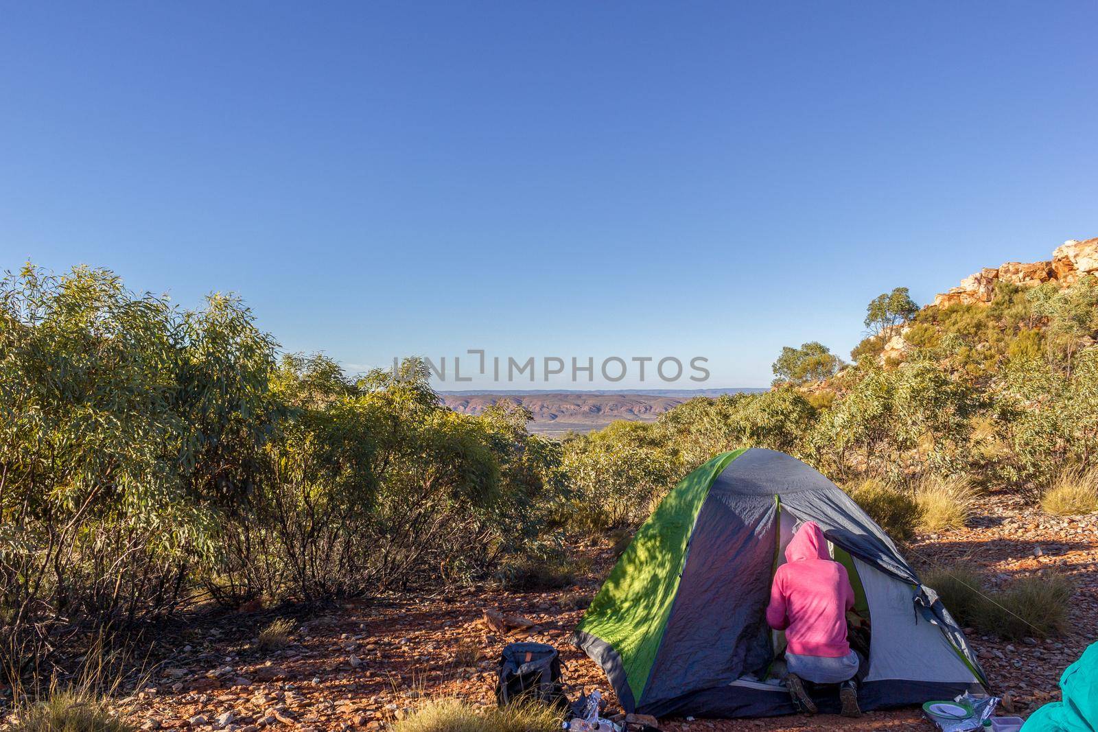 Tourist tent in camp among meadow in the mountain at sunrise with campire, australia by bettercallcurry