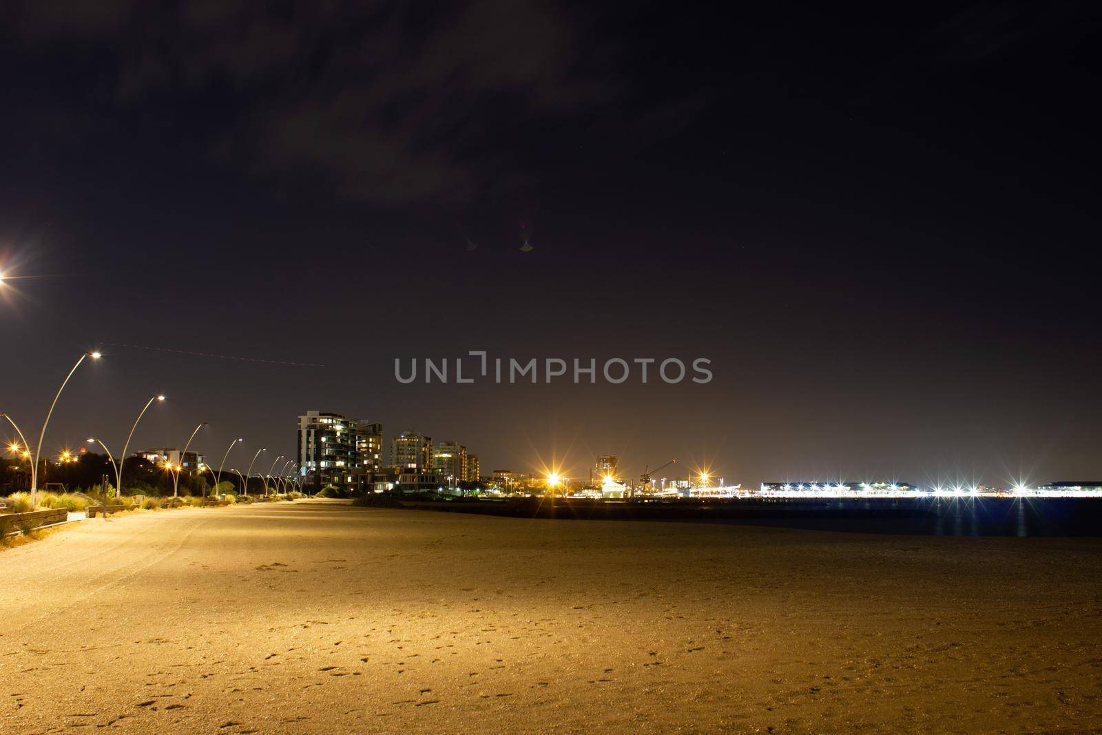 view over melbourne at night from a beach