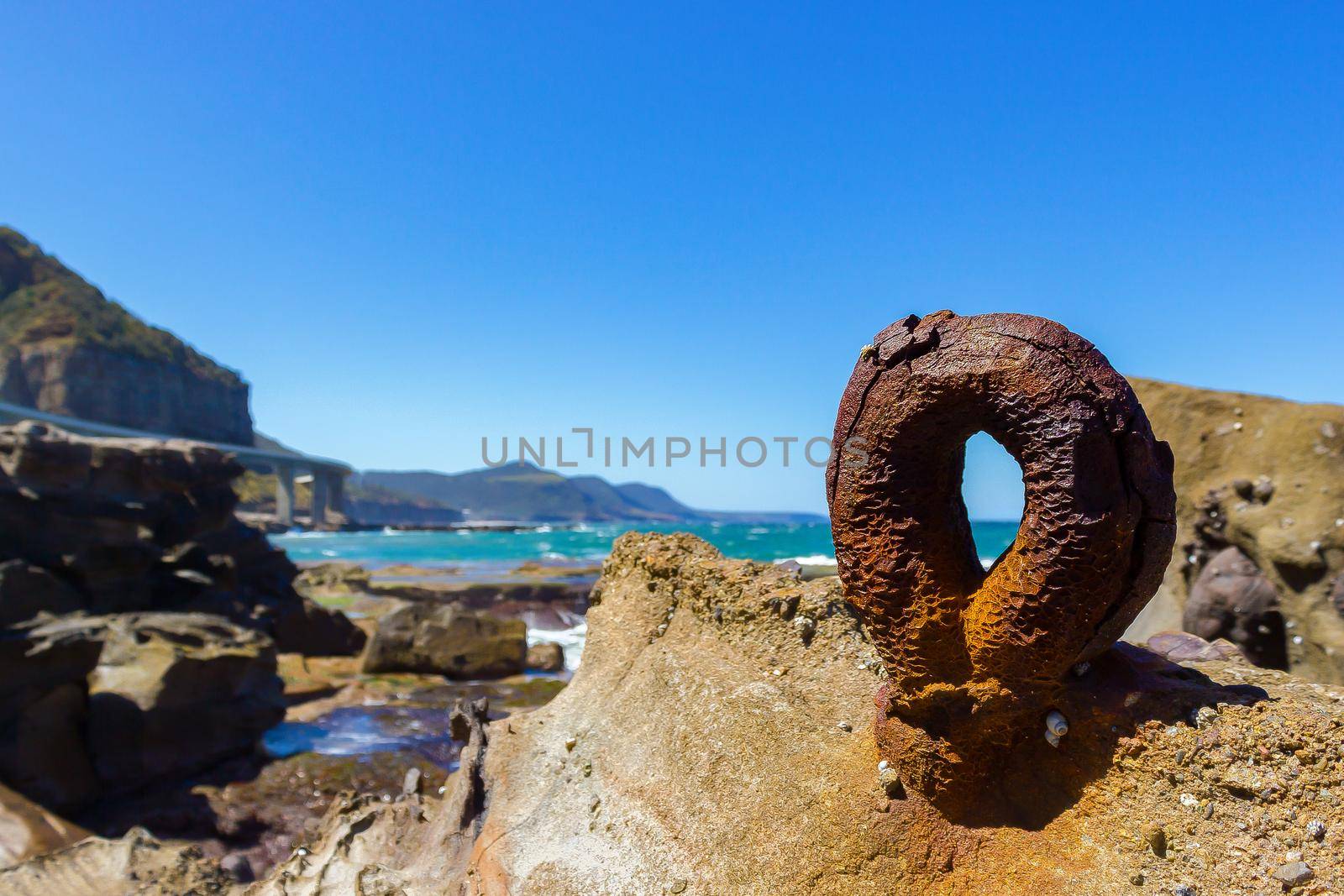 old rusty round hook from the historic Sea Clliff Bridge along the Grand Pacific Drive, Australia by bettercallcurry