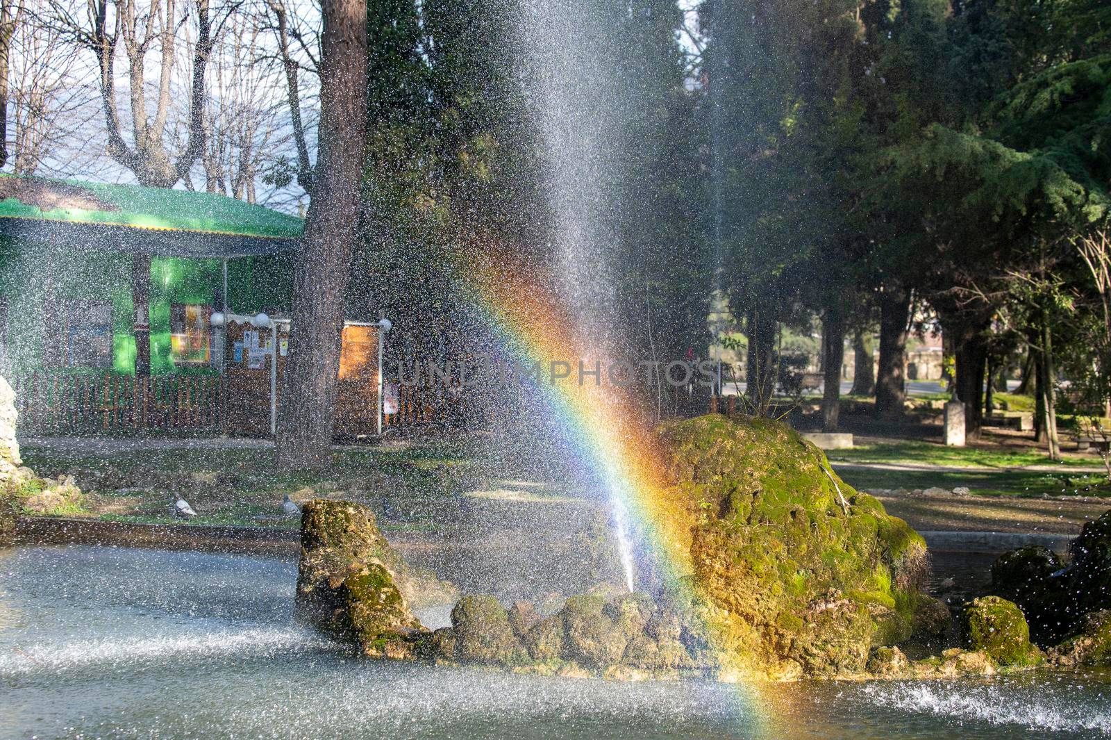 rainbow on the fountain of a park in the city of Terni in the early morning