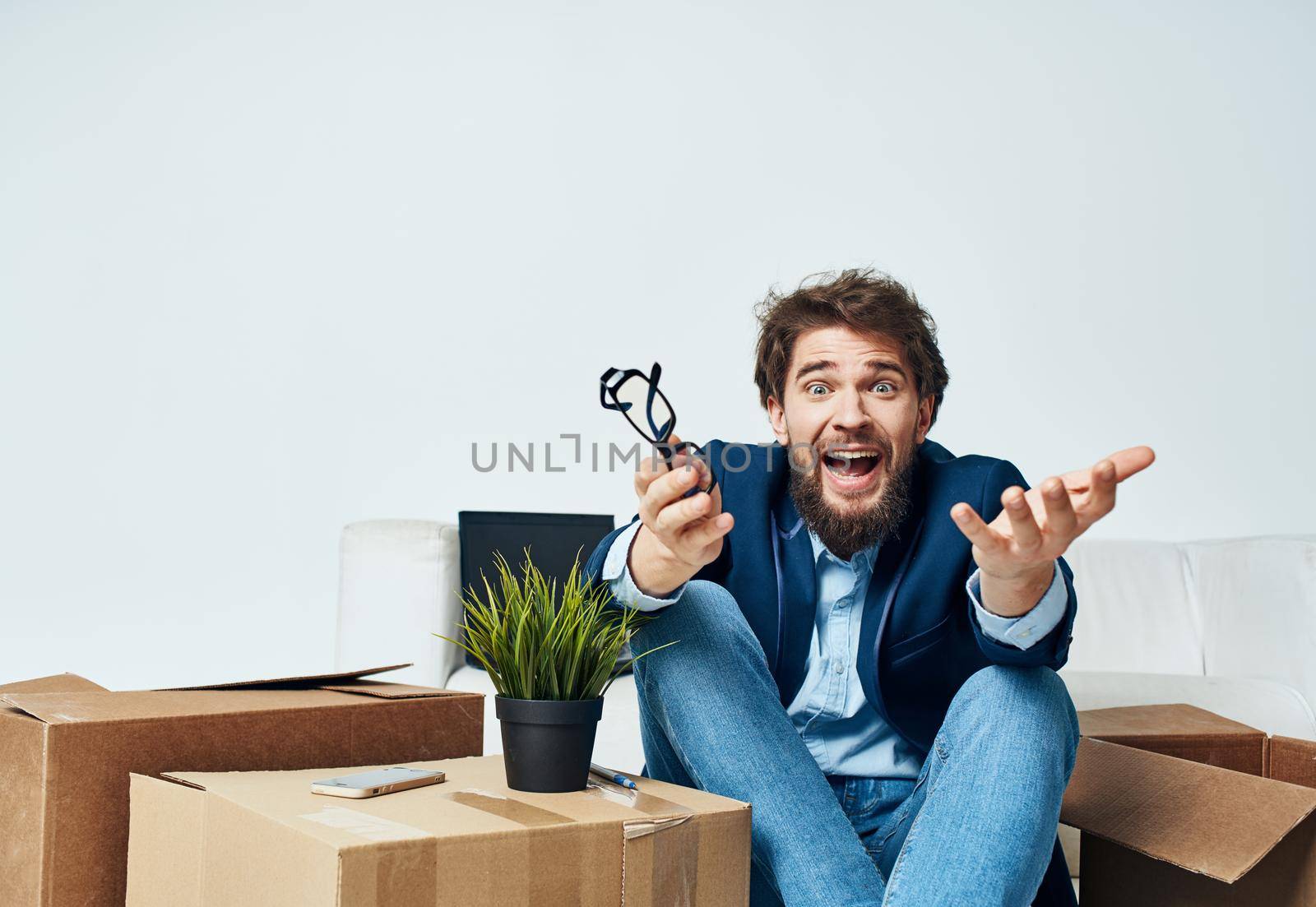 business man office unpacking boxes lifestyle emotions. High quality photo