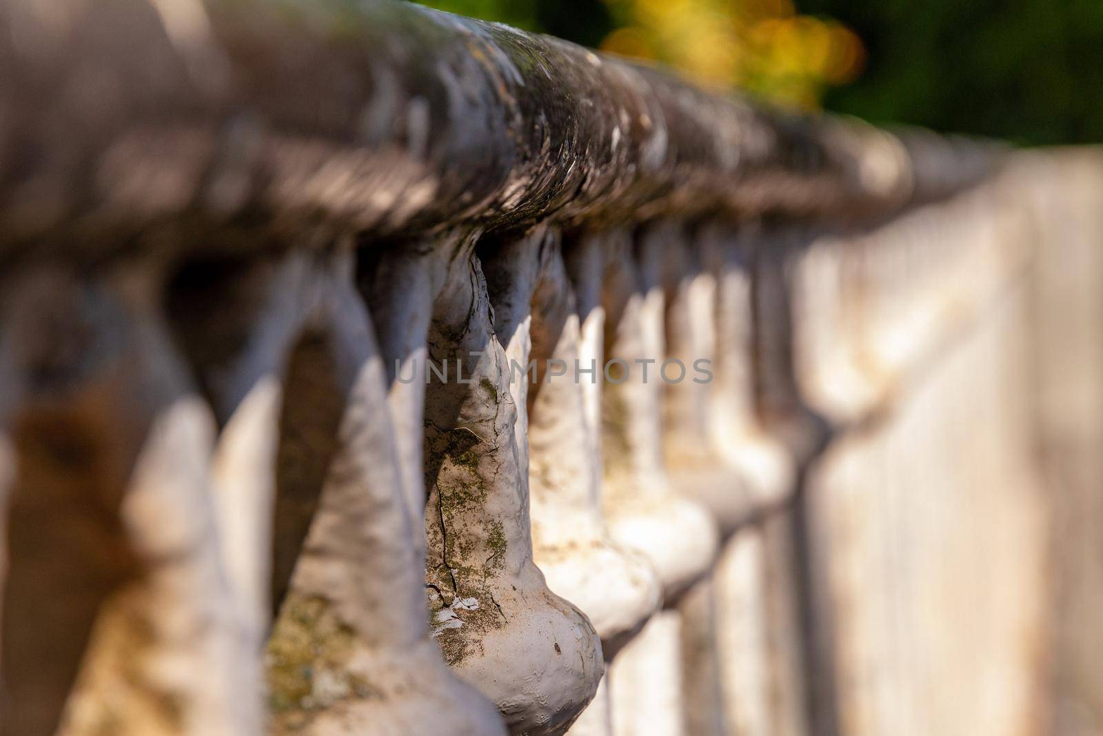 Close-up of an old rusty metal railing on a sunny day