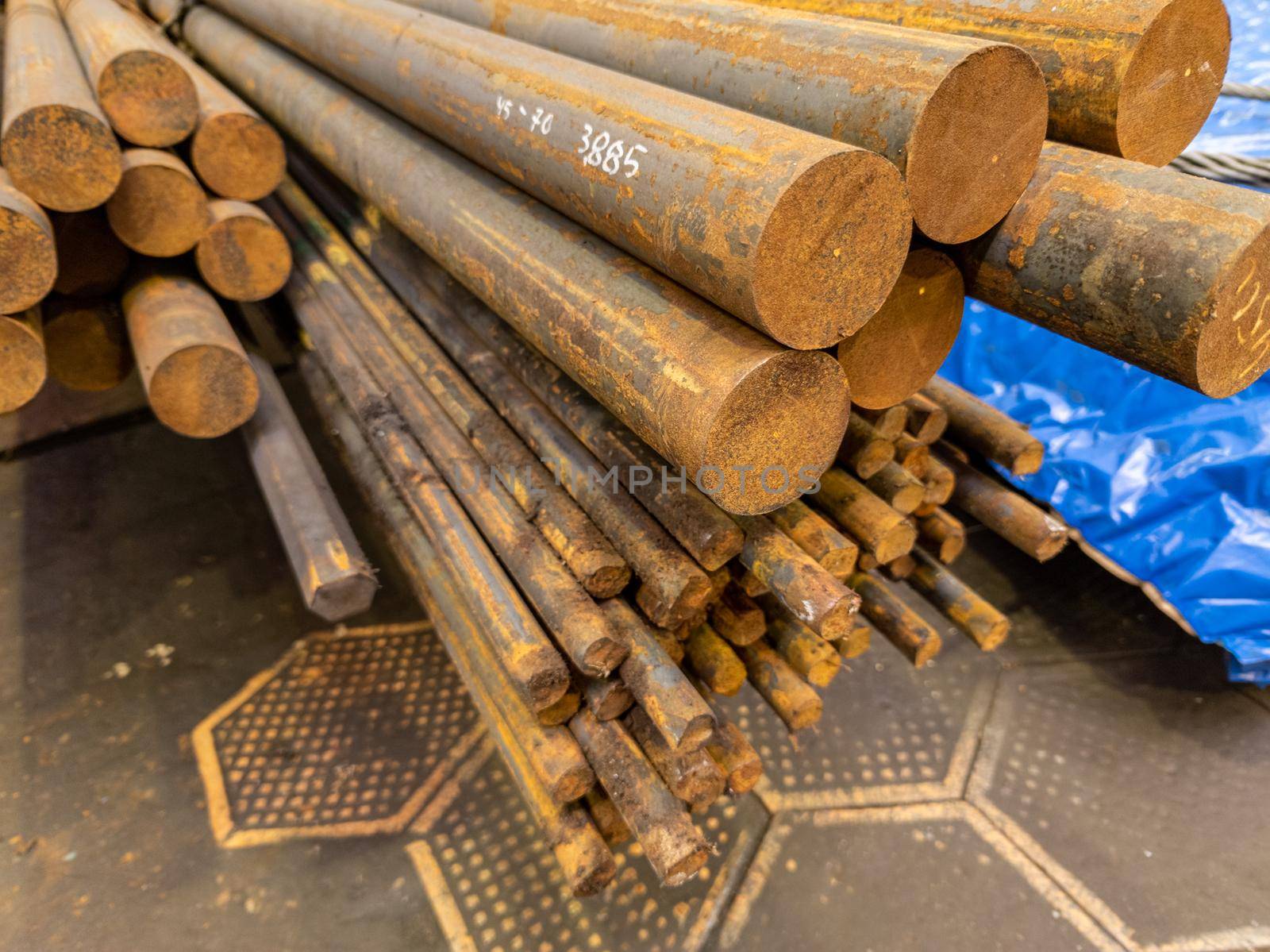 rusted round steel bars pack ends - close-up with selective focus and background blur