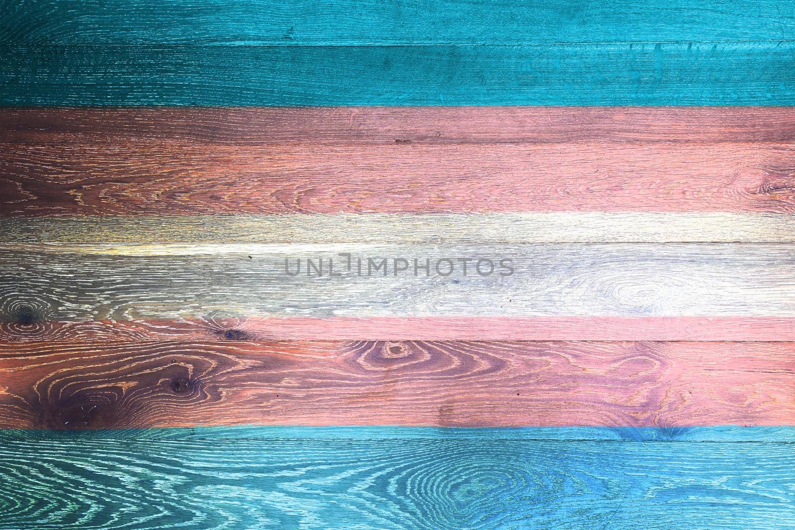 A Transgender Pride flag on rustic old wood surface background blue white pink stripes