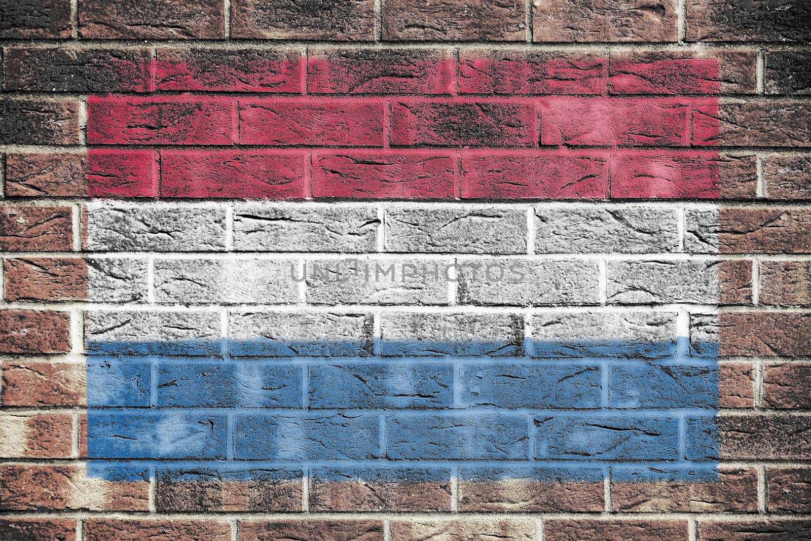 A Netherlands flag on old brick wall background