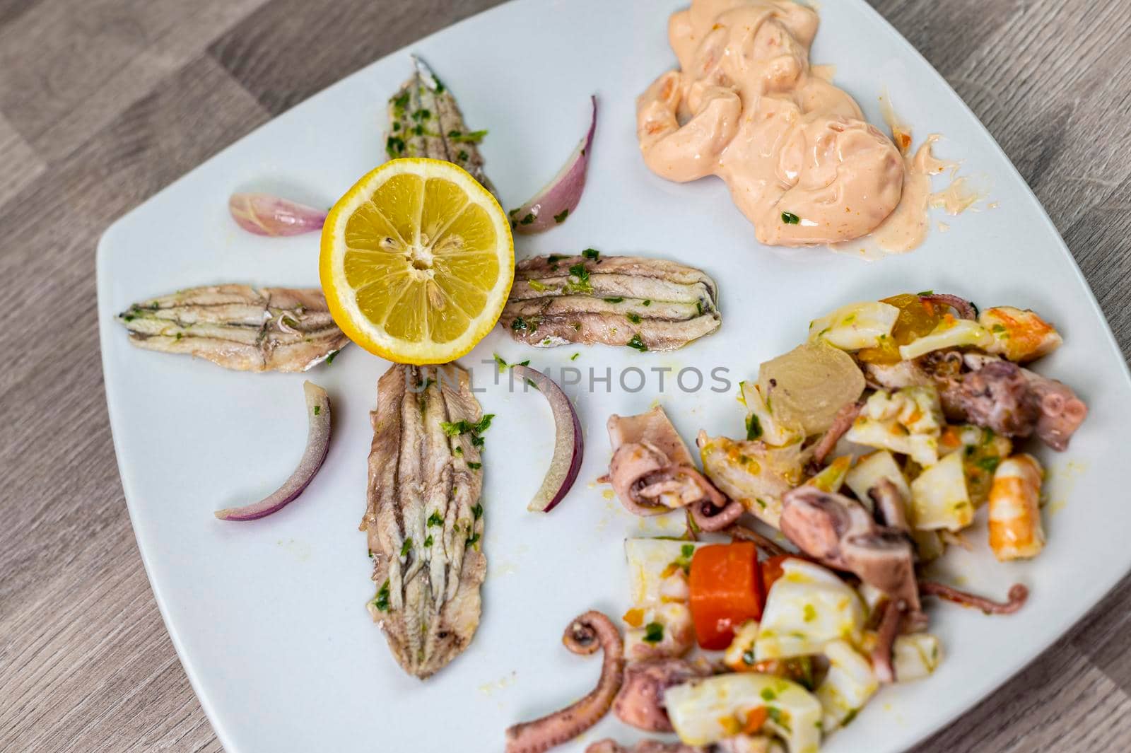 appetizer with seafood goblet of wine and cutlery on wooden background