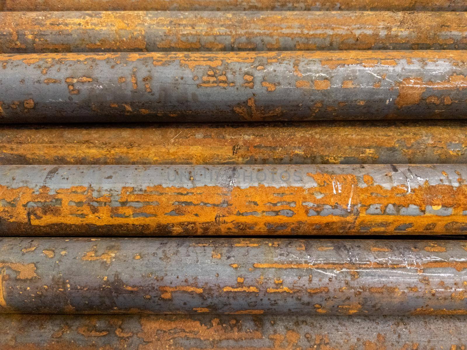 rusted round steel bars pack - full frame close-up background.