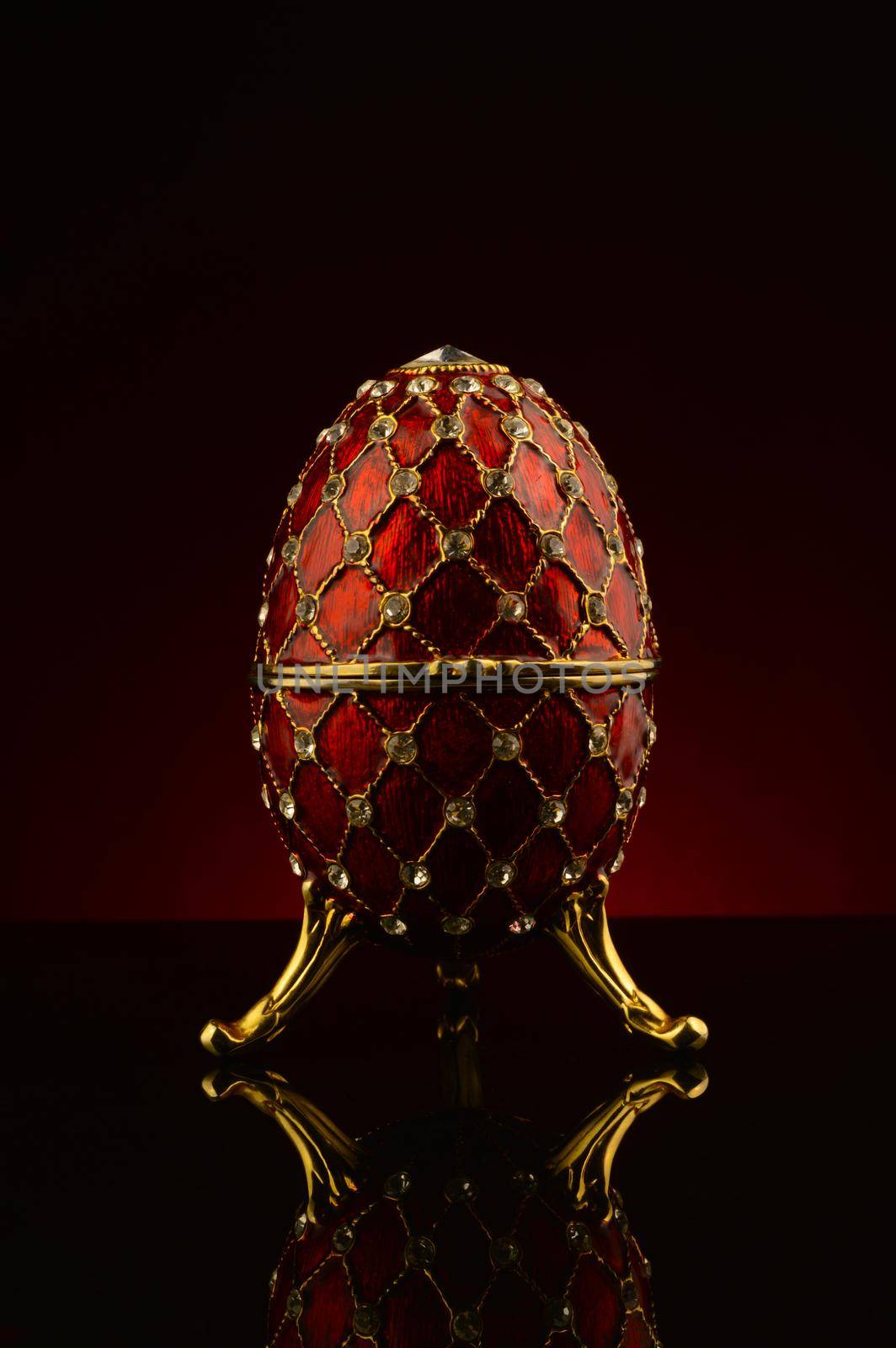 A faberge style egg focused over a dark red and black gradient background.