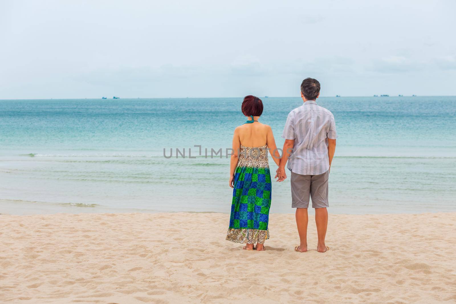 Middle aged couple relaxing at chaweng beach in koh samui ,Thailand.