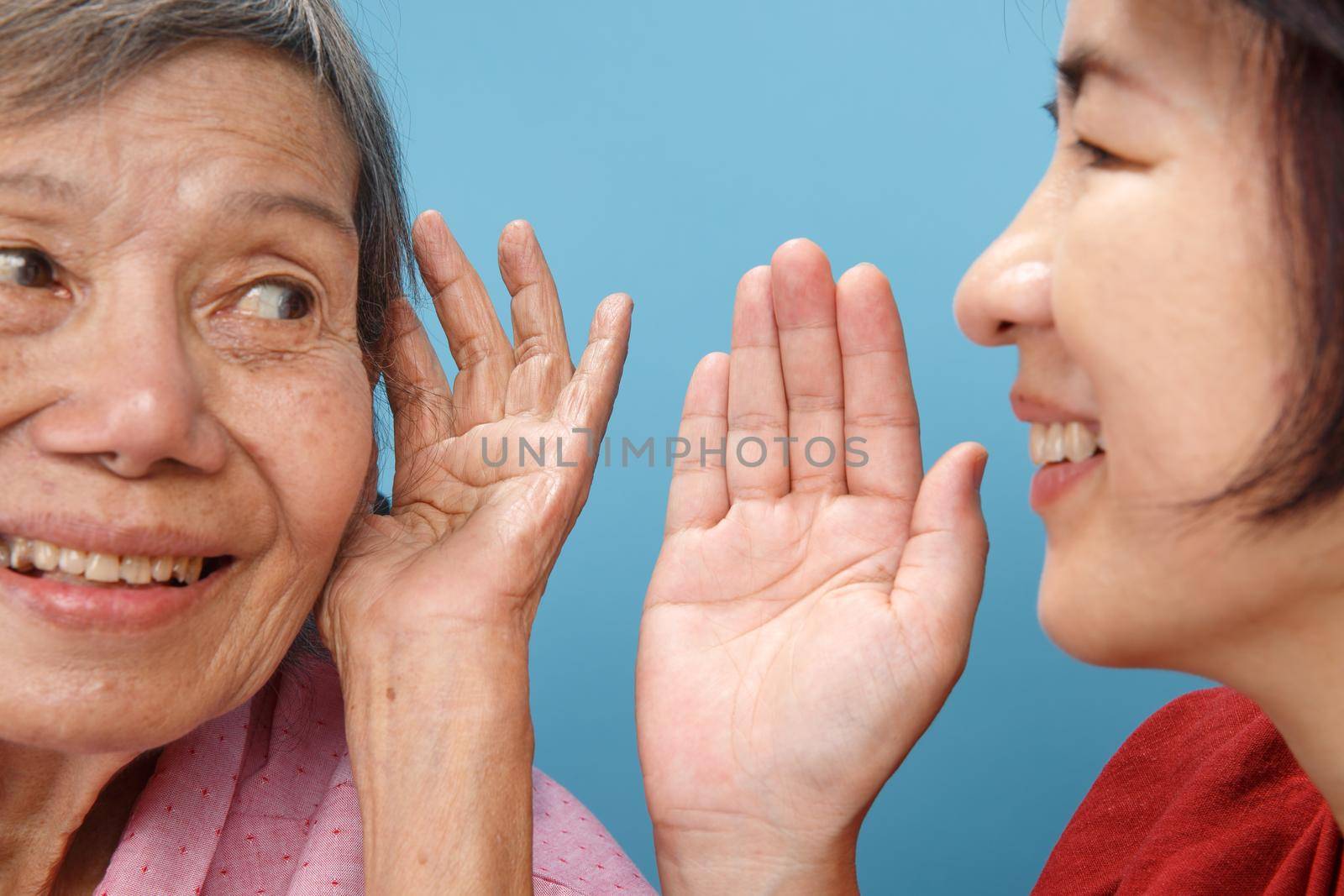 Asian seniors woman hearing loss , Hard of hearing try to talk with daughter.